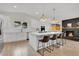 Bright kitchen features a breakfast bar, modern appliances, and a vaulted ceiling at 8357 Dudley Ct, Arvada, CO 80005