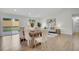 Bright living room features dining area, sliding glass door, and neutral decor at 8357 Dudley Ct, Arvada, CO 80005