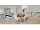 Open concept living room features dining area and modern staircase at 8357 Dudley Ct, Arvada, CO 80005