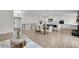 Open concept living room and kitchen area with hardwood floors and plenty of natural light at 8357 Dudley Ct, Arvada, CO 80005
