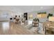 Open concept living room and kitchen area with hardwood floors and plenty of natural light at 8357 Dudley Ct, Arvada, CO 80005