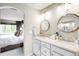 Bright bathroom features double sinks, white cabinetry, and modern fixtures at 15205 W Baker Ave, Lakewood, CO 80228