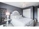 Well-decorated bedroom features an elegant chandelier and unique accent wall design at 15205 W Baker Ave, Lakewood, CO 80228