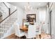 Dining room with wood table, chandelier, and staircase at 15205 W Baker Ave, Lakewood, CO 80228