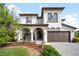 Stunning two-story home featuring a covered front porch, a two-car garage, and manicured landscaping at 15205 W Baker Ave, Lakewood, CO 80228