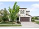 Charming two-story home with a well-maintained lawn, a brown garage door, and inviting curb appeal at 15205 W Baker Ave, Lakewood, CO 80228