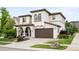Elegant home featuring a two-car garage, covered entrance, and a beautifully landscaped front yard at 15205 W Baker Ave, Lakewood, CO 80228