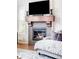 Close-up of a cozy fireplace, showcasing the decor, tile work, and nearby seating area at 15205 W Baker Ave, Lakewood, CO 80228