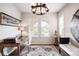 Stylish home office with natural light, plantation shutters, and a decorative chandelier and rug at 15205 W Baker Ave, Lakewood, CO 80228