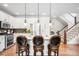 Bright kitchen with white cabinetry, quartz countertops, and stainless steel appliances at 15205 W Baker Ave, Lakewood, CO 80228