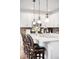 Kitchen island featuring pendant lights, white cabinets, and bar stool seating at 15205 W Baker Ave, Lakewood, CO 80228
