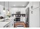 Modern kitchen with stainless steel appliances, white cabinetry, and hardwood floors at 15205 W Baker Ave, Lakewood, CO 80228