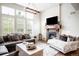 Cozy living room boasting a fireplace, large windows, and stylish decor for a comfortable atmosphere at 15205 W Baker Ave, Lakewood, CO 80228