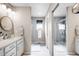 En-suite main bathroom with double sinks, walk-in shower, and neutral color palette at 15205 W Baker Ave, Lakewood, CO 80228