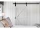 Close-up of the main bedroom featuring barn door leading to main bathroom at 15205 W Baker Ave, Lakewood, CO 80228