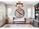 Bright sitting room featuring hardwood floors, a decorative clock, and light-filled windows with shutters at 15205 W Baker Ave, Lakewood, CO 80228