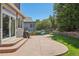 Inviting backyard patio featuring a concrete surface, lush green lawn, and privacy fencing at 8677 S Buchanan Way, Aurora, CO 80016