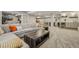 Expansive basement with sectional seating, a bar area, and recreational space at 8677 S Buchanan Way, Aurora, CO 80016