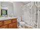 Bathroom with a single vanity, toilet, and a shower/tub with a patterned shower curtain at 8677 S Buchanan Way, Aurora, CO 80016