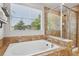 Bathroom features a luxurious soaking tub with tile surround and a glass shower at 8677 S Buchanan Way, Aurora, CO 80016