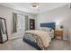 Bedroom with a blue upholstered bed, gray walls, carpet and curtains at 8677 S Buchanan Way, Aurora, CO 80016