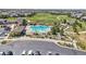 Aerial view of a community pool with lounge chairs, a covered picnic area, and parking at 8677 S Buchanan Way, Aurora, CO 80016