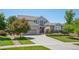 Charming two-story home features a well-manicured lawn, mature landscaping, and a spacious three-car garage at 8677 S Buchanan Way, Aurora, CO 80016