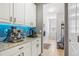 Hallway with a beverage station, granite countertops, and plenty of storage at 8677 S Buchanan Way, Aurora, CO 80016