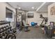 Well-equipped home gym featuring weight machines, free weights, and a treadmill for a complete workout at 8677 S Buchanan Way, Aurora, CO 80016