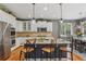 Kitchen with white cabinetry, stainless steel appliances, granite counters, and bar stool seating at 8677 S Buchanan Way, Aurora, CO 80016