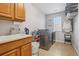 Well-lit laundry room with modern appliances and plenty of cabinet space at 8677 S Buchanan Way, Aurora, CO 80016