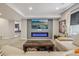 Relaxing living room with a comfortable sectional couch, modern fireplace, and stylish design elements at 8677 S Buchanan Way, Aurora, CO 80016
