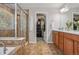 Lovely bathroom featuring a tub, glass shower, and wood cabinets at 8677 S Buchanan Way, Aurora, CO 80016