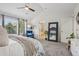 Bright main bedroom boasts a king bed, accent chair, and large windows at 8677 S Buchanan Way, Aurora, CO 80016
