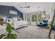 Spacious main bedroom with a king bed, blue accent wall, and lots of natural light at 8677 S Buchanan Way, Aurora, CO 80016
