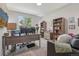 Office with shelves, desk, and comfortable seating at 8677 S Buchanan Way, Aurora, CO 80016