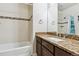 Bathroom featuring a bathtub, tiled shower, and granite countertop sink at 6765 S Old Hammer Ct, Aurora, CO 80016