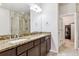 Bright bathroom with double sinks, granite countertops, and tiled shower at 6765 S Old Hammer Ct, Aurora, CO 80016