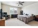 Spacious bedroom featuring carpet, ceiling fan, large windows and a closet at 6765 S Old Hammer Ct, Aurora, CO 80016