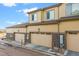Townhome boasts attached garages, neutral siding, stone accents, and well-maintained landscaping at 6765 S Old Hammer Ct, Aurora, CO 80016