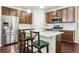 Modern kitchen featuring stainless steel appliances, granite countertops, and ample cabinet space at 6765 S Old Hammer Ct, Aurora, CO 80016