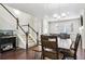 Open-concept living room with a staircase and dining area with access to the kitchen at 6765 S Old Hammer Ct, Aurora, CO 80016