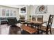 Open-concept living room with a dining table, comfortable seating, and stylish decor at 6765 S Old Hammer Ct, Aurora, CO 80016