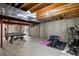 Unfinished basement area with exercise equipment and foosball table at 1194 W 125Th Dr, Denver, CO 80234