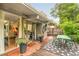 Cozy back patio perfect for entertaining with a dining set, potted plants, and glass door entrance at 1831 S Ivanhoe St, Denver, CO 80224