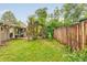 A lush backyard featuring a wooden deck, a charming trellis, and a wooden privacy fence at 1831 S Ivanhoe St, Denver, CO 80224