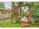 Backyard patio with a wooden deck, outdoor seating, and a charming lattice structure covered in vines at 1831 S Ivanhoe St, Denver, CO 80224