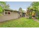 Backyard view showcasing the home's exterior, wooden deck, chimney, and well-maintained lawn at 1831 S Ivanhoe St, Denver, CO 80224