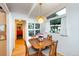 Eat-in kitchen area with bright natural light, views of the outdoors, and white ceiling beams at 1831 S Ivanhoe St, Denver, CO 80224