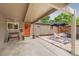 Welcoming view of the home entrance with an open carport and cozy outdoor seating area at 1831 S Ivanhoe St, Denver, CO 80224